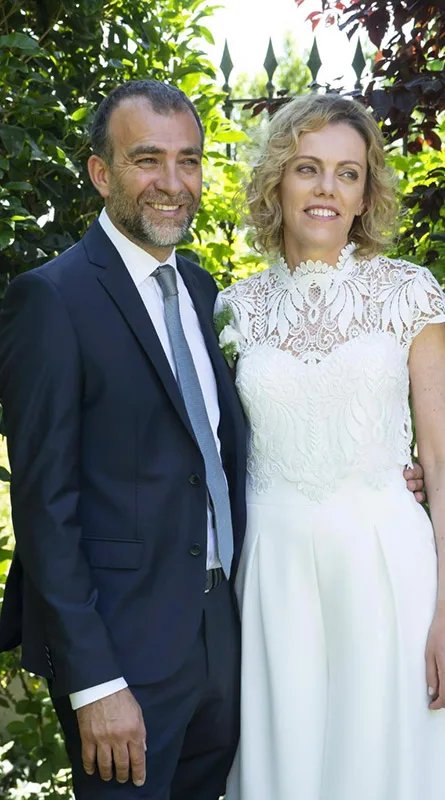 Sposa e sposo in giardino: abito da sposa a due pezzi con corpetto in pizzo a collo alto